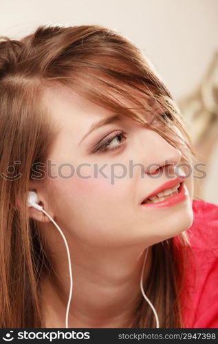 Woman with white headphones listening to music. Student girl learning language with new technology.