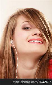 Woman with white headphones listening to music. Student girl learning language with new technology.