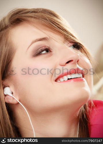 Woman with white headphones listening to music. Student girl learning language with new technology.