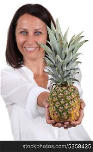 Woman with whole pineapple
