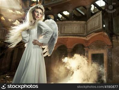 Woman with wings in a decaying building.