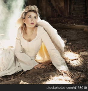 Woman with wings in decaying building.