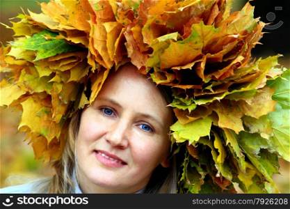 woman with yellow autumn leaves on the head