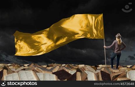 Woman with yellow waving flag. Student girl in casual with yellow flag in hands