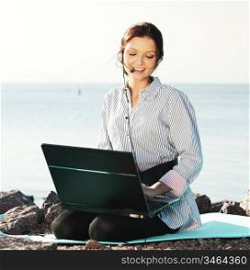 woman work on laptop sea on background