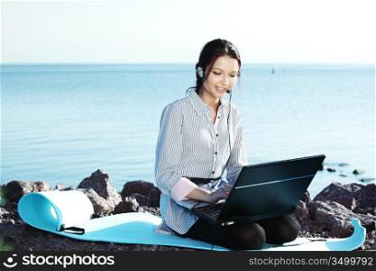 woman work on laptop sea on background