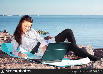 woman work on laptop sea on background