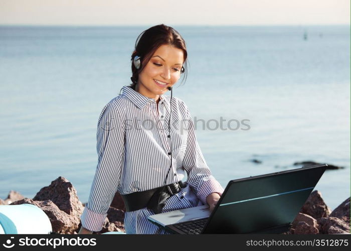 woman work on laptop sea on background