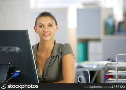 Woman working at a desk computer