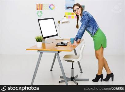 Woman working at desk In a creative office, using a computer 