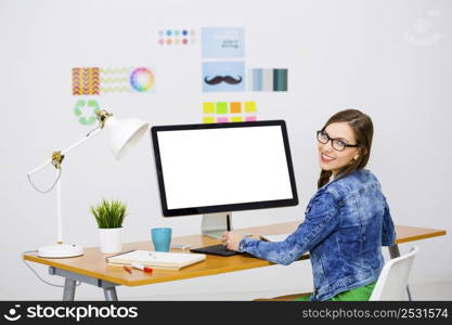 Woman working at desk In a creative office, using a computer