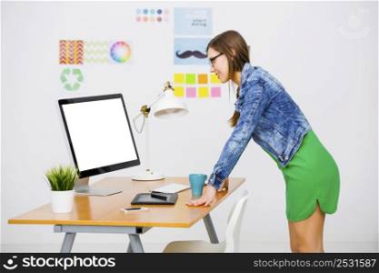 Woman working at desk In a creative office, using a computer