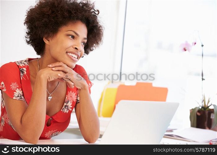 Woman Working At Desk In Design Studio