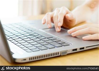 Woman working at home office hand on keyboard close up