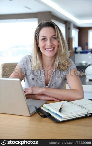 Woman working at home on laptop computer