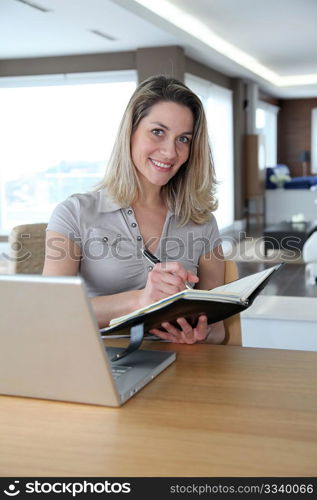 Woman working at home on laptop computer