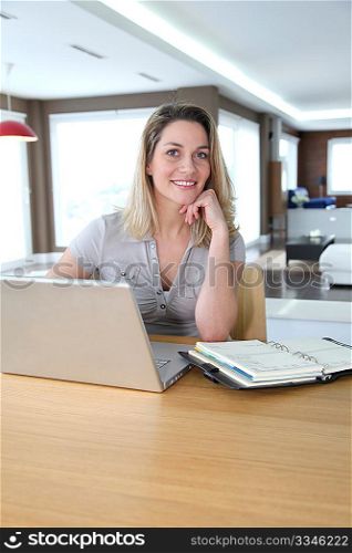 Woman working at home on laptop computer