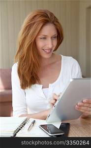 Woman working at home with electronic tablet