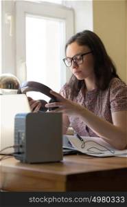 Woman working at home with laptop and architecture plan