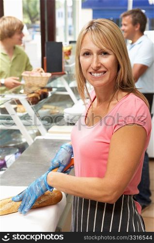 Woman Working Behind Counter In Cafe