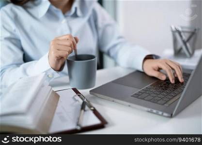 Woman working by using a laptop computer Hands typing on keyboard. Working at office professional investor working new start up project