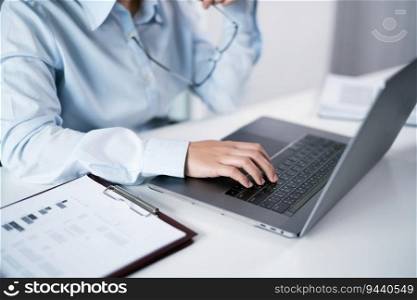 Woman working by using a laptop computer Hands typing on keyboard. Working at office professional investor working new start up project