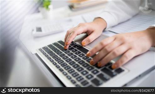 Woman working by using a laptop computer Hands typing on keyboard. writing a blog. Working at home are in hand finger typewriter.