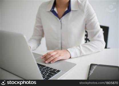 Woman working by using a laptop computerHands typing on keyboard. writing a blog. Working at home are in hand finger typewriter
