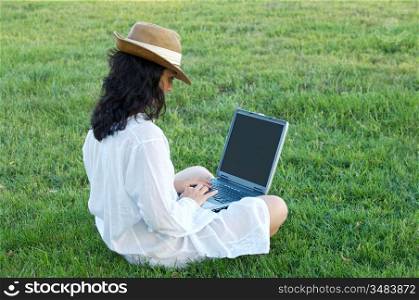 woman working comfortably on the grass