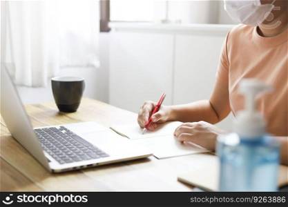 Woman working from home wearing protective mask. COVID-19 Pandemic Coronavirus home isolation auto quarantine wearing face mask protective for spreading of disease virus SARS-CoV-2. Working from home and Cleaning hands with sanitizer gel.