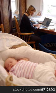 woman working from home with baby