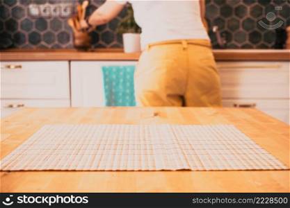 woman working in blurred kitchen interior and wooden desk space home background