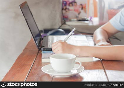 Woman working in coffee shop, stock photo