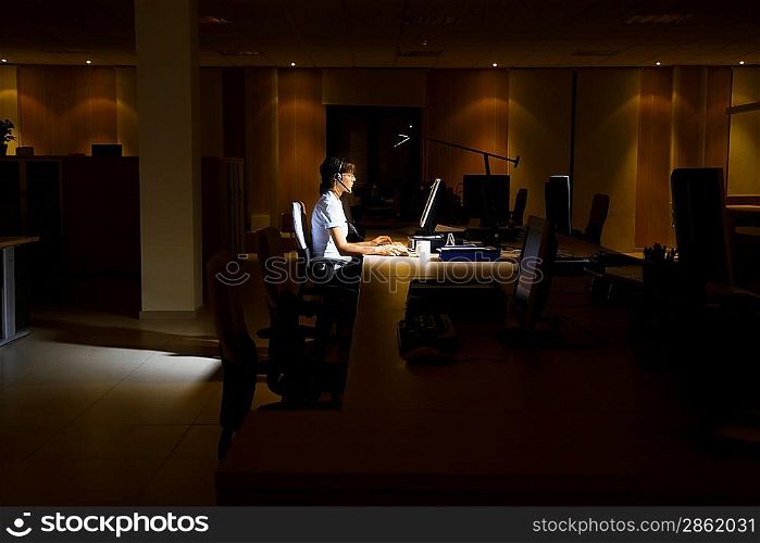 Woman Working in Dark Office