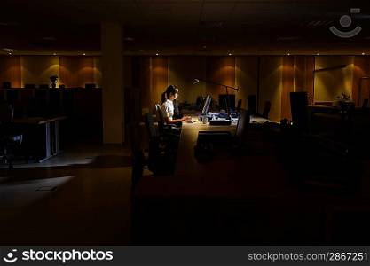 Woman Working in Dark Office