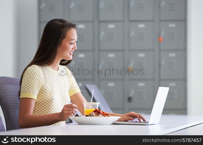 Woman Working In Design Studio Having Lunch At Desk