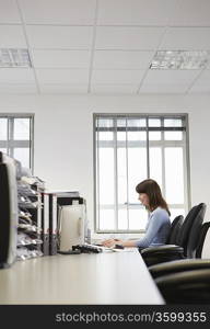 Woman working in office, side view