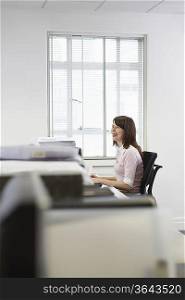 Woman working in office, side view