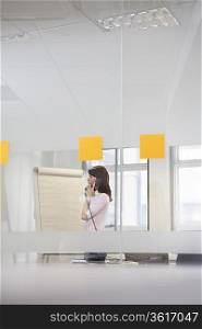 Woman working in office, talking on phone