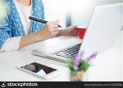 Woman Working Laptop huge Loft Studio.Student Researching Process Technology Workplace Concept in Creative Startup modern Office Analyze market stock and holding white mug