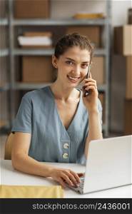 woman working laptop talking phone