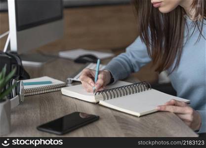 woman working media field writing stuff down notebook