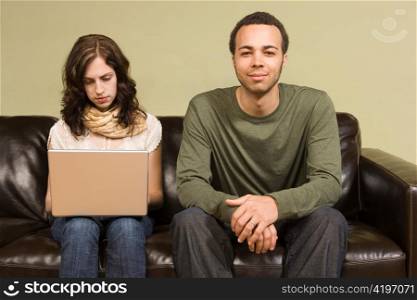Woman Working on Computer while Man Looks On