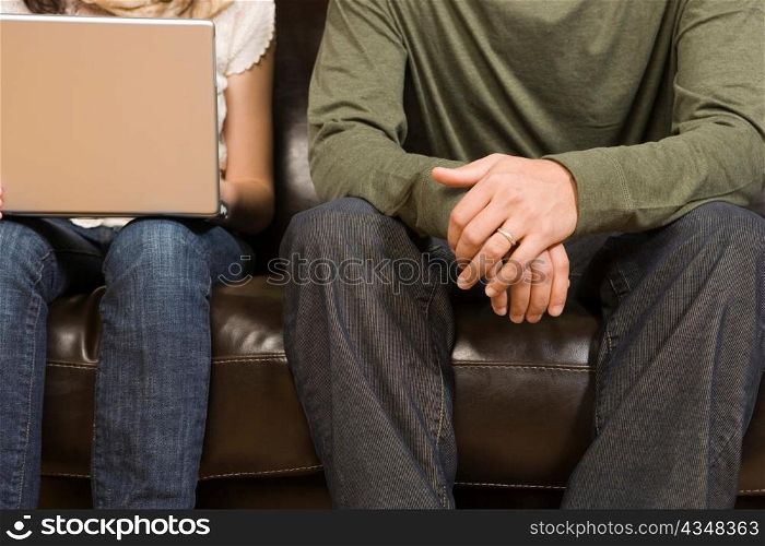Woman Working on Computer while Man Sits
