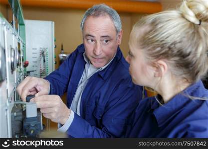 woman working on electronic device with teacher
