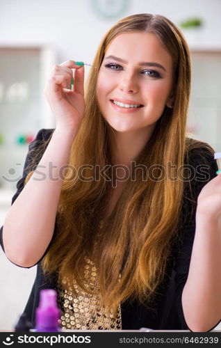 Woman working on her eyelashes in beauty concept