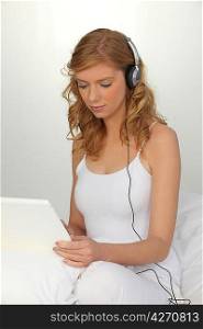 Woman working on laptop with headphones