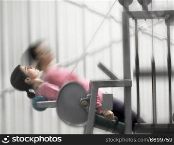 Woman Working Out On Exercise Machine