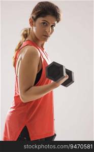 Woman working out with dumbbells. 