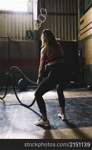 woman working out with rope gym
